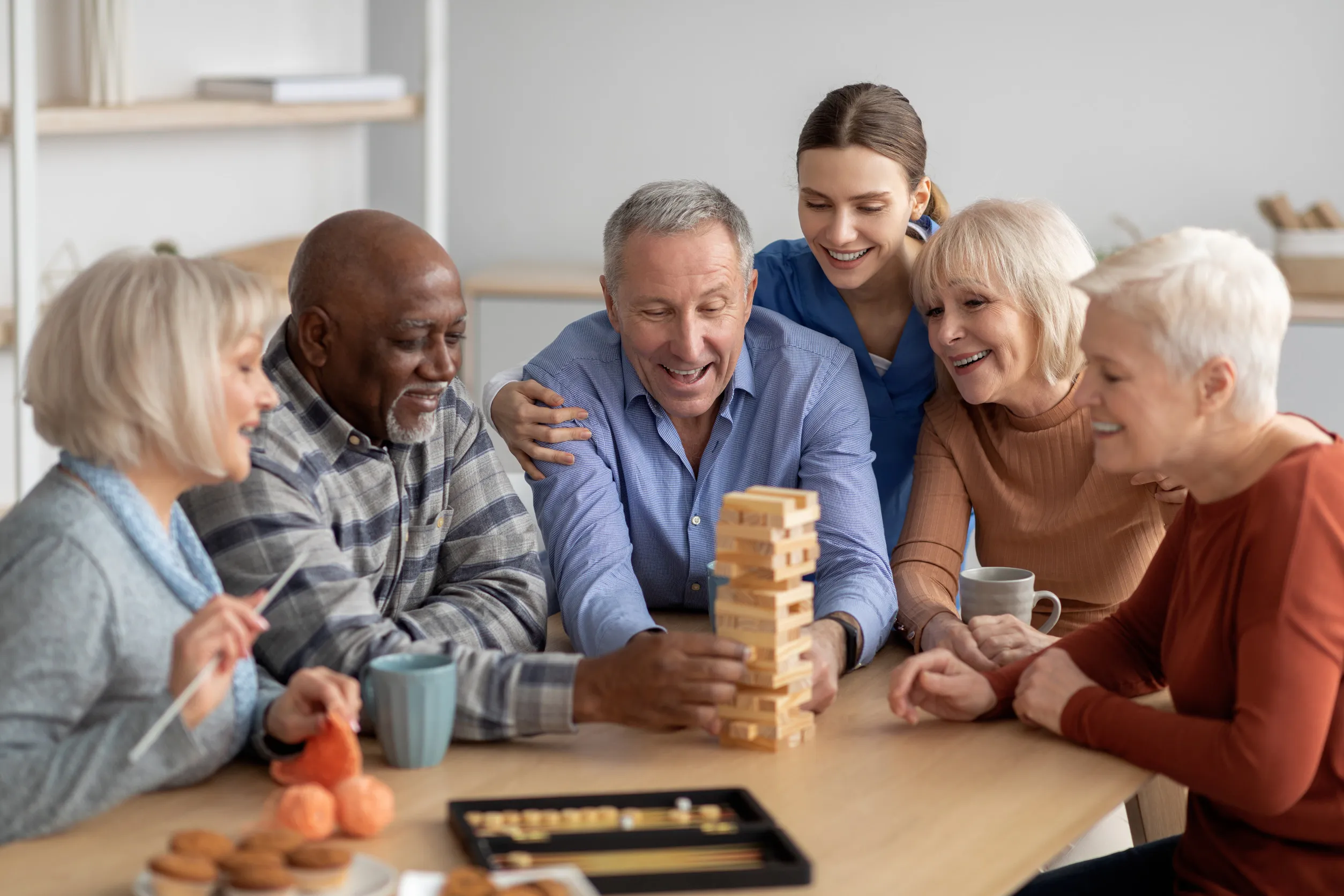 Cheerful multiracial senior people playing jenga at sanatorium Cheerful multiracial senior people playing jenga at sanatorium